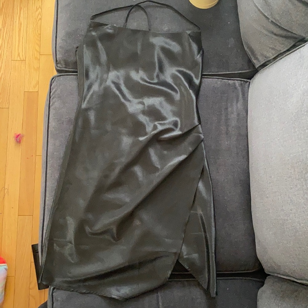 Short black silky dress with a slit in the side and cross back spaghetti strap